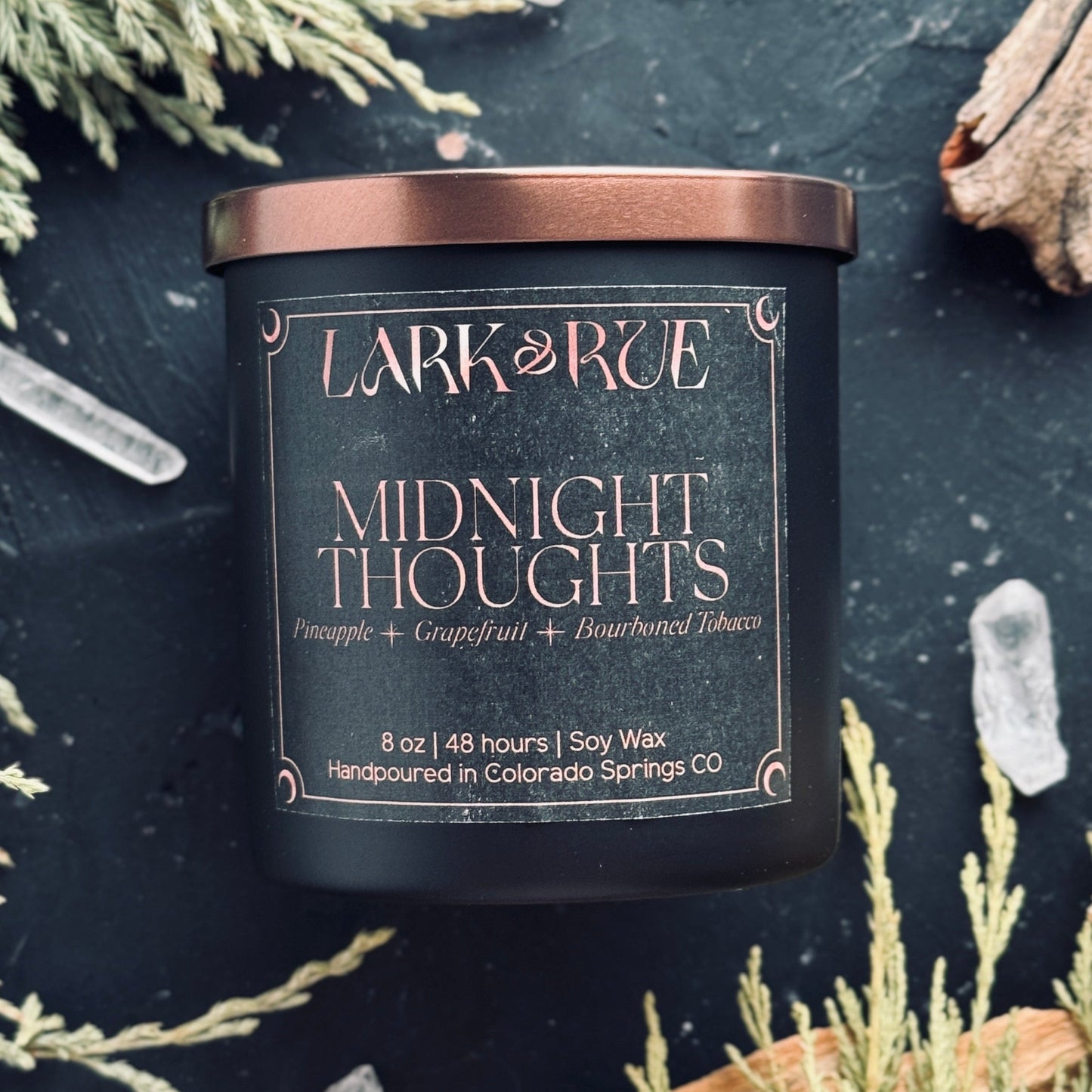Midnight Thoughts by Lark & Rue on a dark background with dried cedar and quartz points.