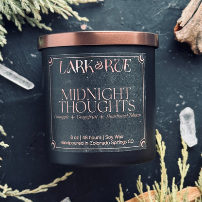 Midnight Thoughts by Lark & Rue on a dark background with dried cedar and quartz points.